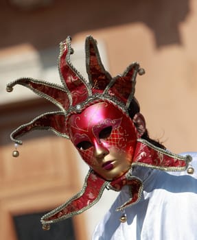 Image of a red venetian mask with bells.