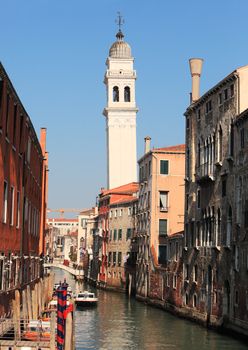 Image of a traditional narrow waterway between old buildings in Venice.