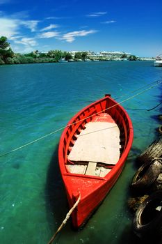 A red fishing boat on blue water