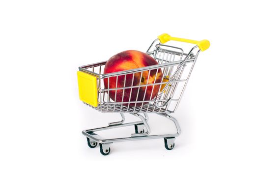 Shopping cart with a large peach on white background