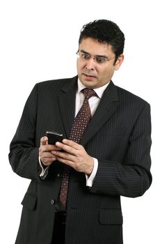 An attractive Indian businessman in his late thirties looking at his cell phone with shock.