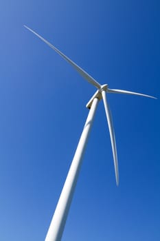 A wind turbine under clear blue sky