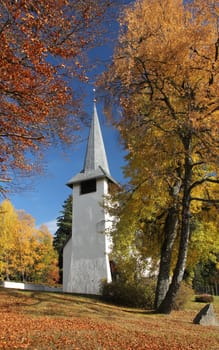 nice church with yellow and orange colored trees of the autumn