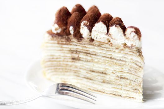 Portion of Tiramisu Mille crepe on a plate