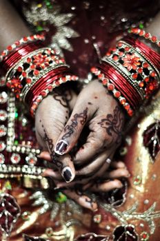 An Indian bride and the henna artwork on her hands