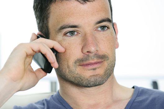 relaxed man with having a communication with a cellephone