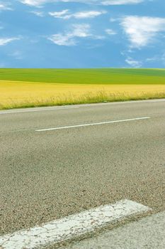 Landscape with road, fields and sky