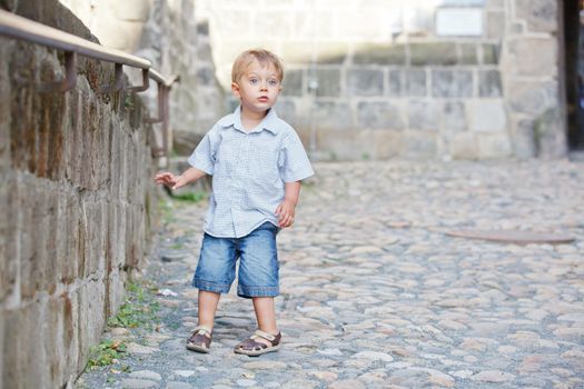 cute little boy outdoors in city street