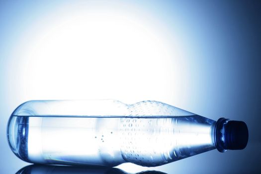 water bottle on a shiny surface in studio