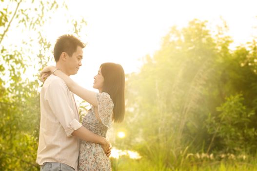 Young couple in love, outdoor in sunset