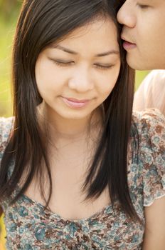 Close up Loving Asian couple whispering