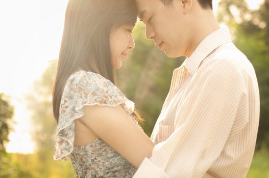 Young couple in love, face to face in sunset