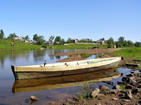 wooden boat near villages