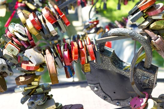 many different colored padlocks hung in a row