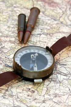 Old military compass on the map and cartridges, shallow dof