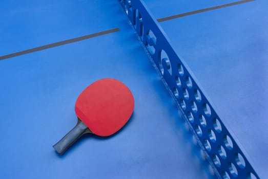 Detail of urban outdoor table tennis with red bat.