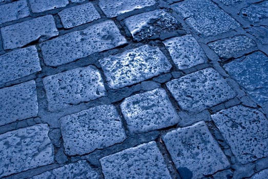 Detail of an old croatian cobblestone road at midnight.