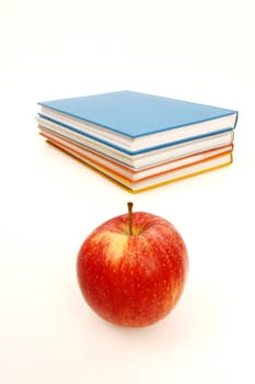 A book stack with some apples on it