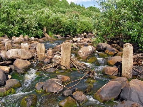 aging destroyed dam on small river