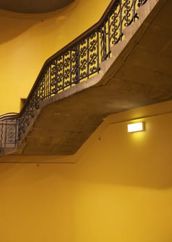 Antique stairwell interior, yellow wall
