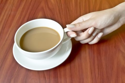 A woman holds a cup of coffee