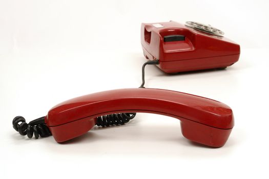 a red retro phone on white............