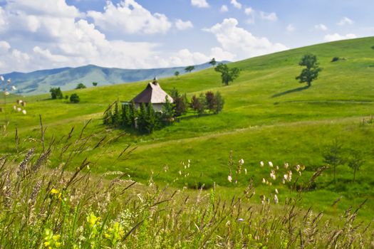 mountain valley and old wood shack