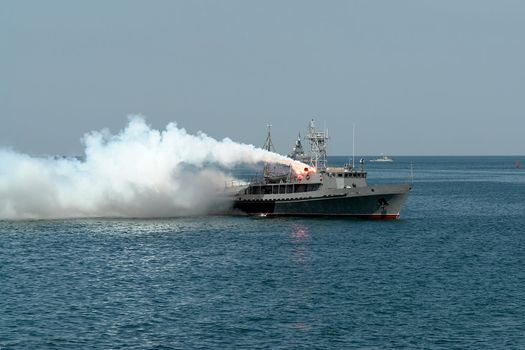 Fire by the military ship in the high sea