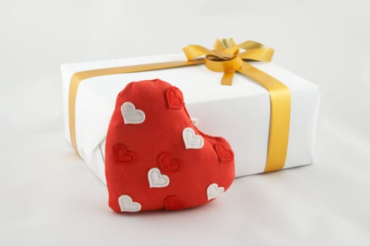 Box with a gift, tied up by a tape with a bow. A gift on "Valentine's day"
