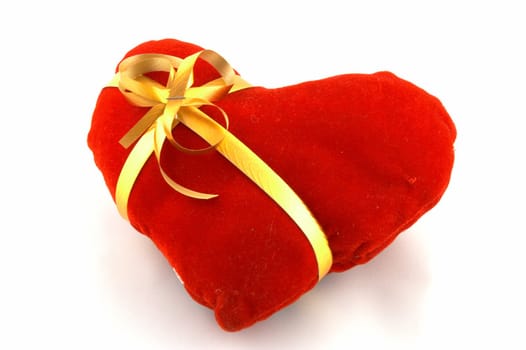 The heart which has been tied up by a tape with a bow. A gift on "Valentine's day"