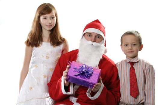 Santa together with two children and a gift on a white background