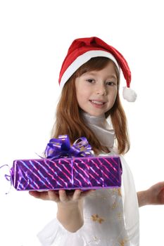 The girl in a white dress and cap Santa holds gift