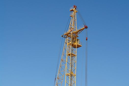 building tower crane against the blue sky