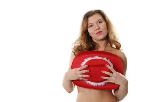 The sexual woman poses holding in hands a red hat