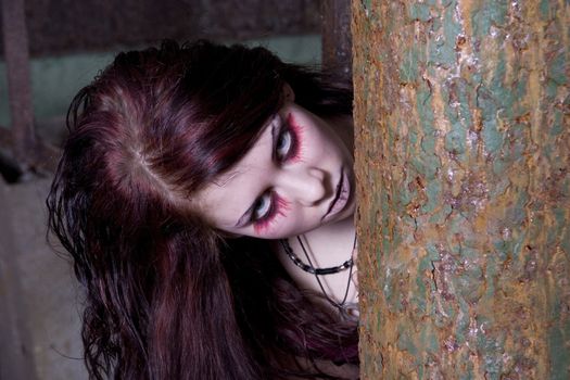 The woman-vampire looks because of a rusty gloomy pipe