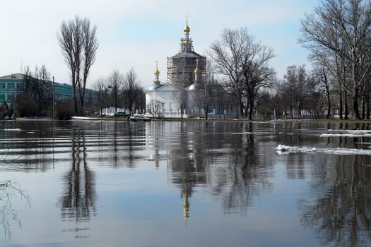 The orthodox temple is reflected in the spring river