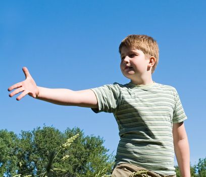 A little boy with sky at background