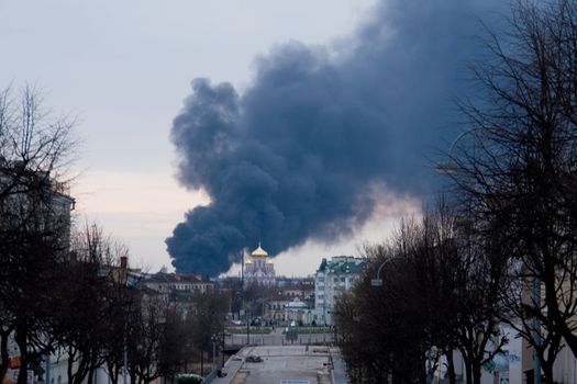 Fire. Black smoke curls above the city.