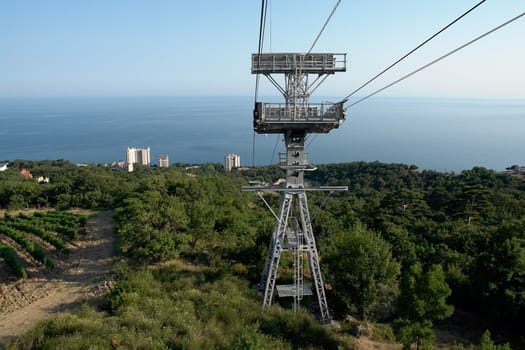 a cableway with sea coast at background