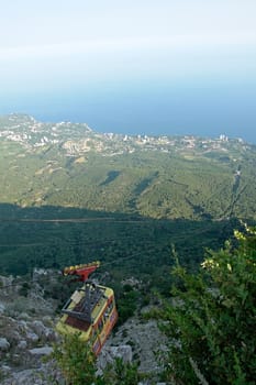 a cableway with sea coast at background