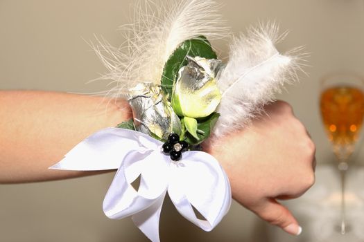 a young girls hand with a beautiful corsage before the prom