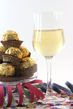 celebration and party time paper confetti streamers wine glass and snacks isolated on white background