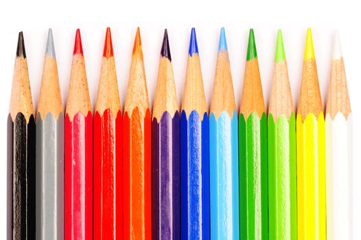 A row of coloured pencils on a white background.