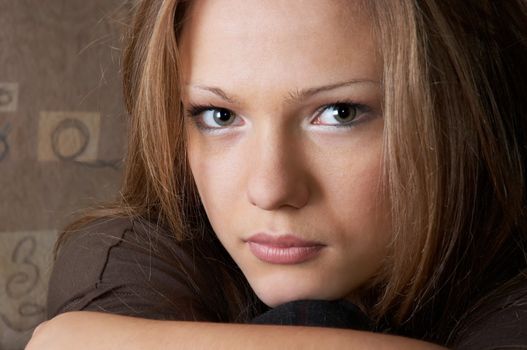 young beautiful woman with probing, slightly sad glance