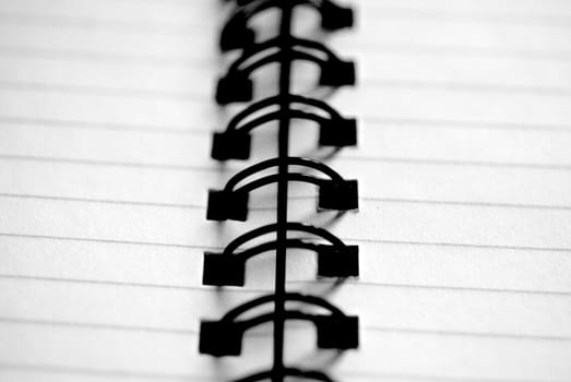 A spiral-bound notepad close-up in black and white