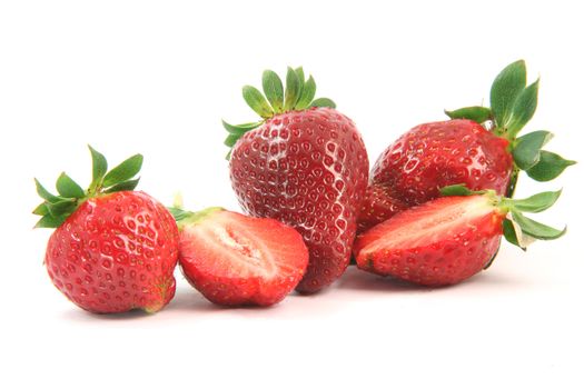 group of strawberries close-up one is cut in half isolated on white background healthy eating