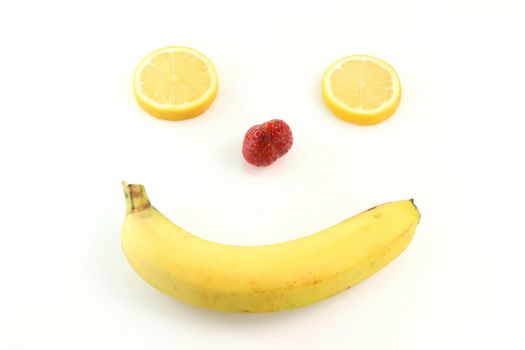 happy fruit face from banana mouth strawberry nose and eyes of lemon  humorous isolated on white background