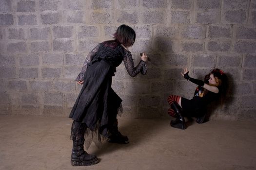 The girl in Gothic style attacks a defenceless victim