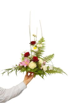 beautiful bouquet holding by man's left hand. isolated on white.