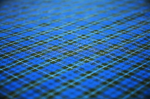 checkered blue celtic fabric textured background. shallow DOF.